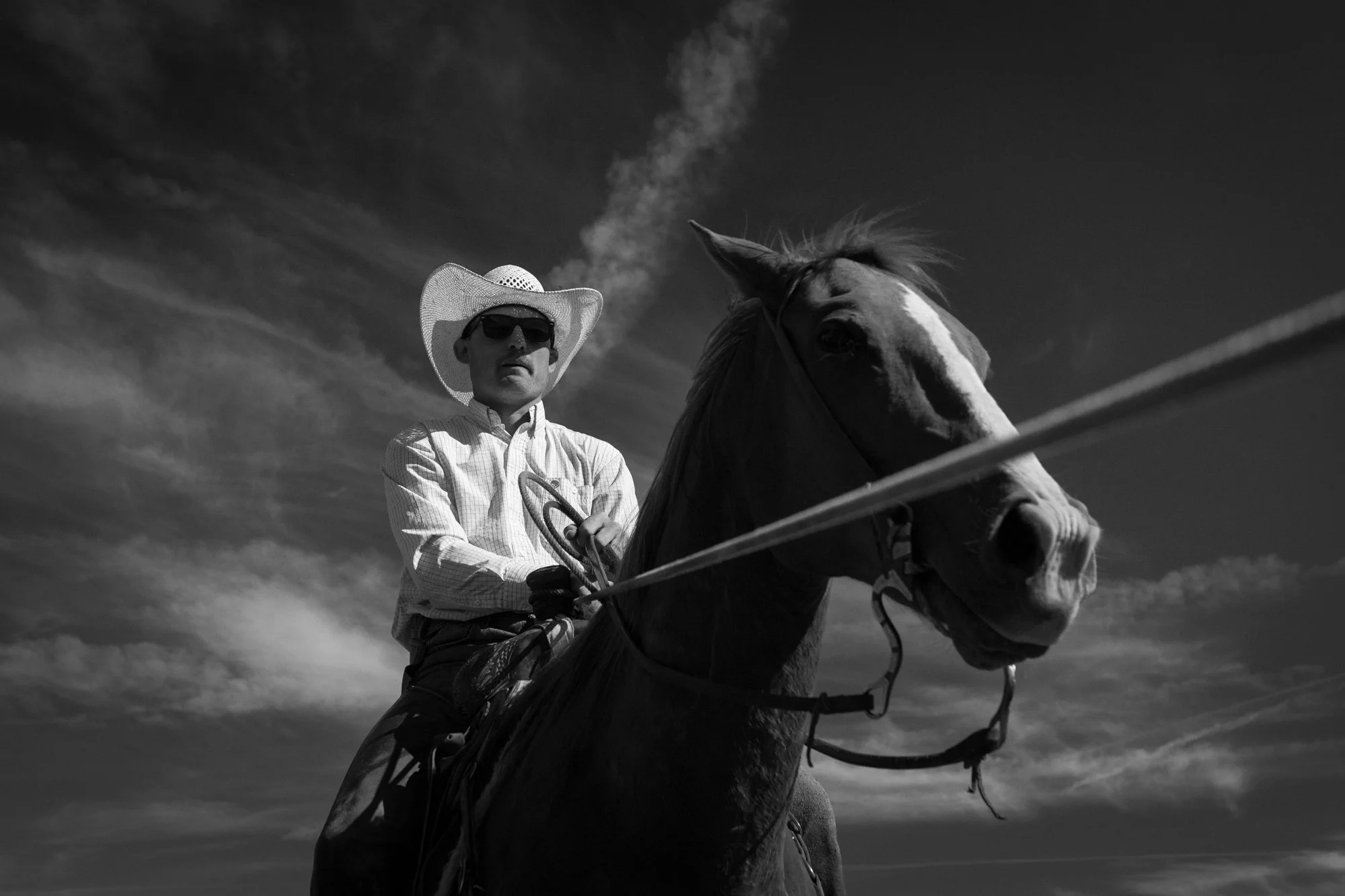 Cowboy on horseback at golden hour